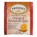 A package of Twinings Orange & Cinnamon Spice Herbal Tea Bags with text and an orange slice.