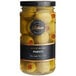 A jar of Belosa Pimento Stuffed Queen Olives with a yellow label on a table.