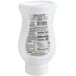 A white plastic bottle of Real Blueberry Puree Infused Syrup with black and white labels.