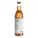 A close up of a bottle of Capora Caramel Flavoring Syrup with a white label.