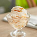 A glass dish with Oringer Salty Caramel Variegate ice cream in it.