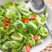 A plate of Brussels sprouts salad with Lee Kum Kee Sichuan peppercorn flavored oil on a white background.