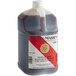A jug of Nielsen-Massey Madagascar Bourbon Vanilla Extract with a red, black, and gold label and a white cap.