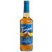 A Torani Sugar-Free Classic Hazelnut flavoring syrup bottle with a blue label filled with brown liquid.