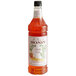 A bottle of Monin candy corn flavoring syrup on a white background. The label is orange and white.