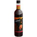 A bottle of DaVinci Gourmet Classic Caramel Pecan flavoring syrup with brown liquid.
