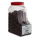 A plastic container with brown Regal Whole Star Anise.