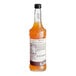 A close-up of a bottle of Monin Zero Calorie Natural Pumpkin Spice Flavoring syrup with a label.