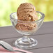 A bowl of Oringer maple walnut hard serve ice cream with a spoon.
