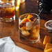 A glass of ice and Monin Butterscotch flavoring syrup.