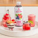 A white tray with a Smartfruit Blooming Berry Puree drink jar and a group of drinks.