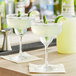 Two margaritas made with Finest Call Premium Lite Margarita Mix on a table.