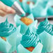 Cupcakes with teal green frosting made using Chefmaster teal green food coloring.