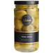 A jar of green olives stuffed with onions on a yellow surface.