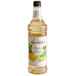 A bottle of Monin Exotic Citrus Flavoring Syrup with a label.