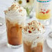 Two glasses of Monin Sugar Free Almond flavoring syrup drinks with whipped cream and nuts.