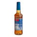 A plastic bottle of Torani Sugar-Free Classic Hazelnut flavoring syrup with a blue label.