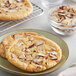 A plate of Nielsen-Massey almond butter cookies with sliced almonds on top.