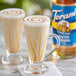 Two glasses of coffee with Torani Sugar-Free Salted Caramel syrup in it and caramel sauce swirls on top.