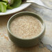 A bowl of celery seed soup and a plate of salad on a table.