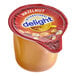 A close up of a plastic container of International Delight Hazelnut creamer with a lid.