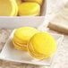 A plate of yellow macaroons.