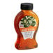 A case of 6 bottles of Dutch Gold Orange Blossom Honey on a table with a label.