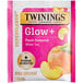 A pink and white Twinings packet with a pink label for 16 peach and aloe vera flavored white tea bags.