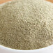 A bowl of Regal Ground Marjoram powder on a wooden table.