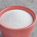 A bowl of Regal Stevia Sweetener on a gray surface.