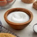 A bowl of sugar and cookies on a counter.