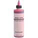 A close-up of a Chefmaster deep pink food coloring container with a black cap.