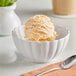 A bowl of Oringer mango ice cream on a table.