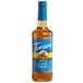 A 750 mL glass bottle of Torani Sugar-Free Classic Caramel Flavoring Syrup with a blue label.