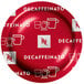 A red Nespresso Professional Decaffeinato coffee capsule on a white plate.