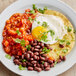 A plate of food with Goya Adobo seasoned beans and a fried egg.