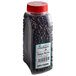 A plastic container of Regal Juniper Berries with a black label.