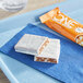A ONE Coffee Shop Caramel Macchiato Protein Bar in blue packaging on a blue tray.