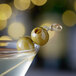 A close up of a martini with Belosa jalapeno stuffed queen olives on top.