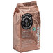 A brown bag of Lavazza Tierra! Selection whole bean espresso coffee on a white background with a close up of the label.