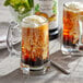 A glass mug of Monin root beer with ice cream on top.
