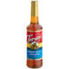 A Torani brown sugar cinnamon flavoring syrup plastic bottle with a red label.