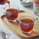 A couple of glass cups of Numi Organic Aged Earl Grey Loose Leaf Tea on a tray.