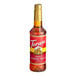 A Torani 750 mL plastic bottle of almond roca flavoring syrup with a red label.