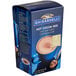 A blue box of Ghirardelli hot cocoa mix packets.
