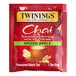 A red package of Twinings Spiced Apple Chai Tea Bags with a label.