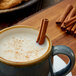 Regal cinnamon sticks in a mug of milk.