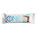 A white package of ONE Birthday Cake Protein Bars with a piece of cake on it.