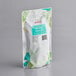 A white Bossen Jasmine Green Tea bag with green and blue designs.