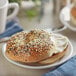 A bagel with cream cheese and Regal Everything Bagel Seasoning on a plate.